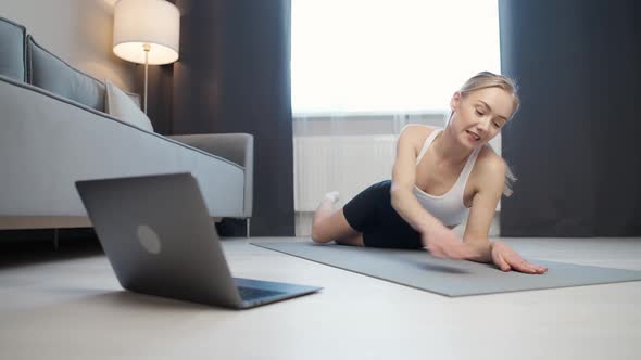 Wellness Female Coach Makes a Workout Online Makes a Live Stream for Social Networks Using a Laptop