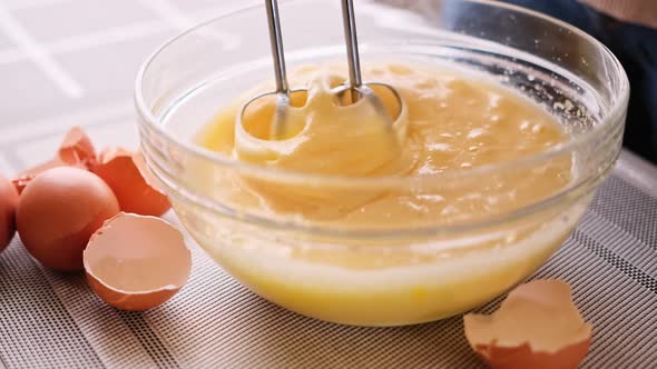 Closeup Person Preparing Homemade Omelette Beating Eggs with Mixer