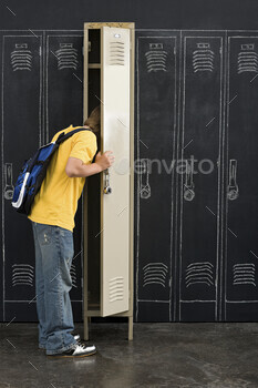 Teenager at a locker in school