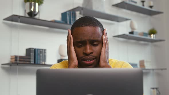 Young frustrated man because of bad news on the internet. The stress of receiving bad news at home