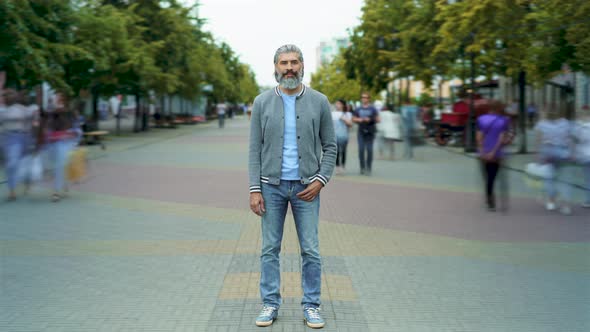 Time Lapse of Goodlooking Mature Man in Trendy Clothing Standing Outdoors in Busy Street