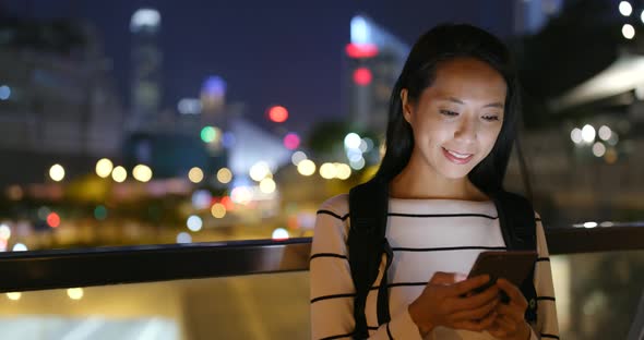 Woman use of mobile phone at night