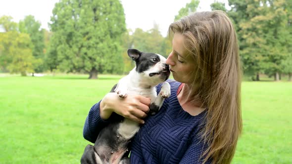 Attractive Happy Woman Carries French Bulldog - Dog Licks Her Face - Friends - Windy Day