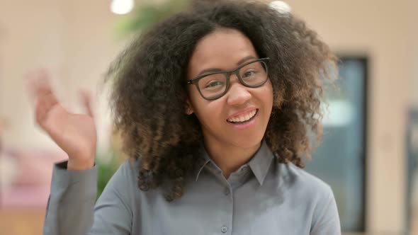 Portrait of Beautiful African Businesswoman Waving Welcoming