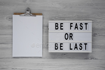 'Be Fast or Be Last' on a lightbox, clipboard with blank sheet of paper.