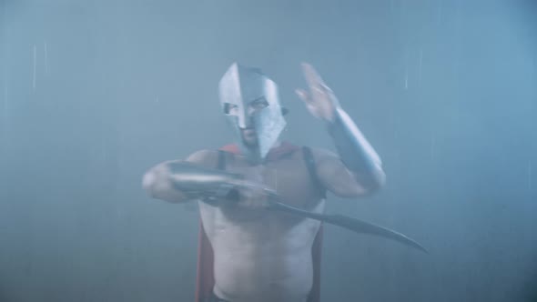 Shirtless Spartan in Armor Swinging Blade Under Rain.