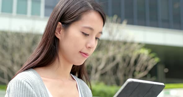 Woman look at tablet computer at outdoor