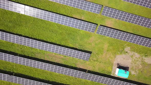 Aerial view of solar power plant on green field. 