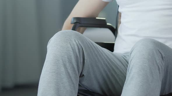 Man in Wheelchair Turning Back to Camera, Inconsolable Condition Bitterness