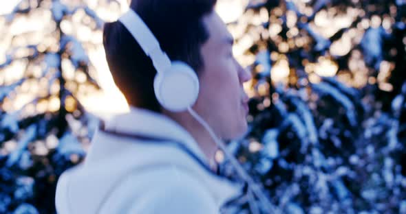 Man listening music on headphones during workout 4k