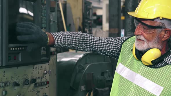 Senior Factory Worker Teach How to Use Machine Equipment in the Factory Workshop