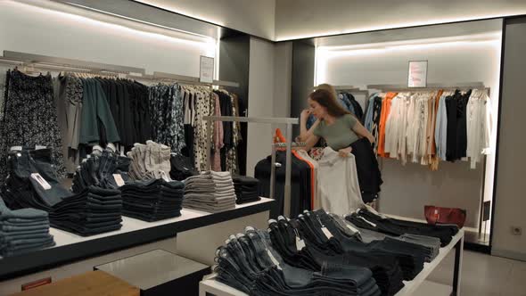 Female Friends Choosing Clothes in Shop