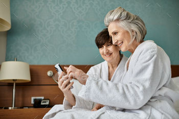 Intimate Moment: Senior Lesbian Couple Sharing a Phone