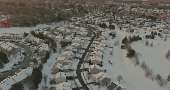 Aerial View of Snowed in Traditional Housing Suburbs in Snow on Trees in Winter Panorama View