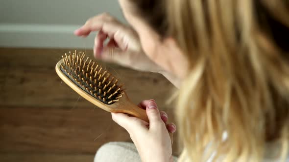 Drop-down Hair in Female Hands with Comb