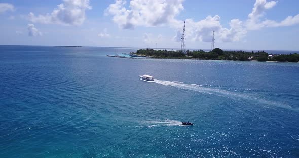 Tropical drone tourism shot of a sandy white paradise beach and aqua blue water background in hi res