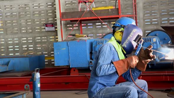 Sitting Worker Welding