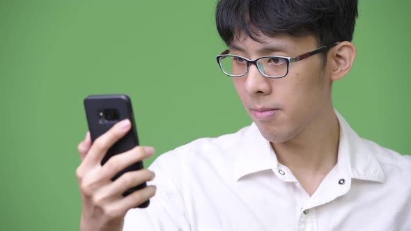 Young Asian Businessman Using Phone