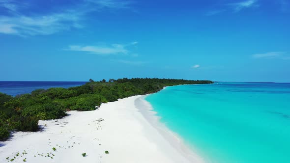 Natural aerial island view of a white sand paradise beach and blue water background in hi res 4K