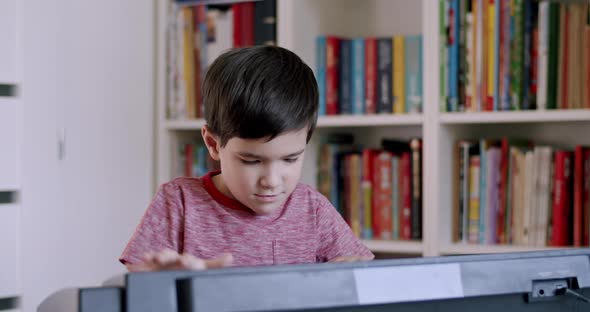 Child Enthusiastically Playing on Piano Electronic Keyboard