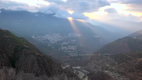 City on Deep Valley and Steep Slope in Mountains