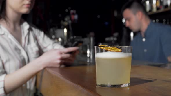 Woman Taking a Cocktail From Bar Counter at Nightclub