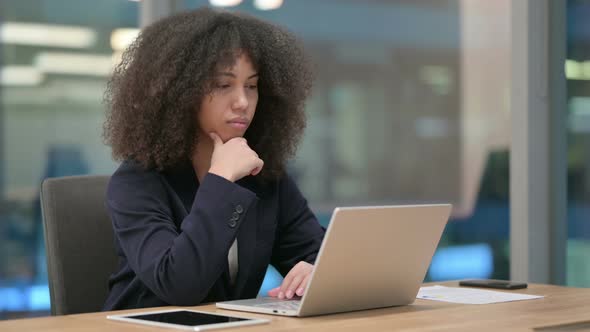 African Businesswoman Thinking Using Laptop