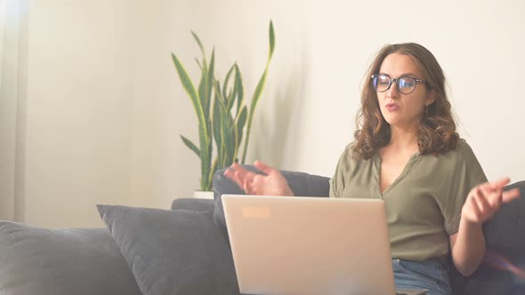 Young Female Freelancer Using Laptop for Video Call