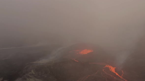 Clouds Of Smoke From An Erupting Volcano With Boiling Molten Lava. - Aerial Shot