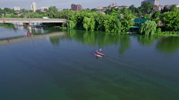 Pretty Women Paddle on Sup Board at River During Sunrise