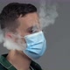 Young Caucasian Male Exhaling Steam From Vape Through Medical Mask - VideoHive Item for Sale