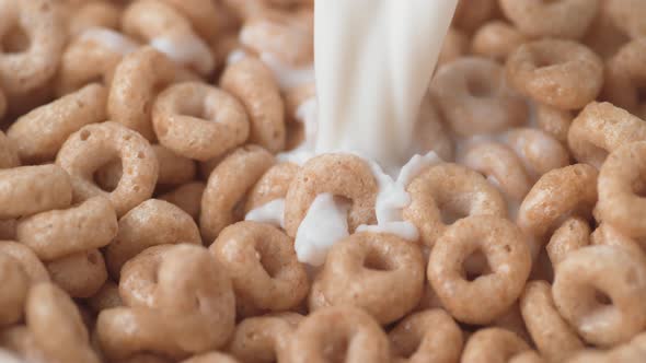 Pouring milk into cereal. Slow Motion.