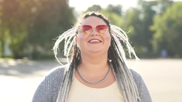 Close-up Portrait of Joyful Young Woman with Bright Hair, Pink Colorful Glasses Cute Face and Dental