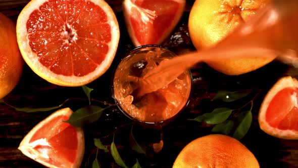 Super Slow Motion Fresh Grapefruit Juice Pours Into the Glass