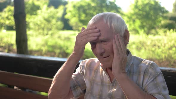 Old Man Holding His Head.