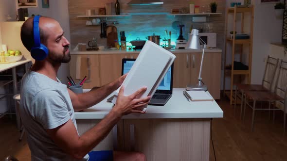 Architect Holding Building Model While Working on a Project