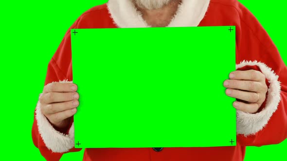 Mid section of santa claus holding blank placard