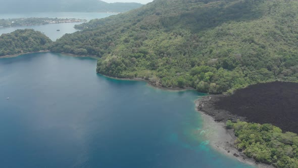 Aerial: flying over Banda Islands active volcano Gunung Api lava flows Indonesia