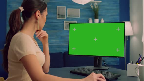 Caucasian Female Searching on Computer with Mock Up Green Screen Chroma Key Display