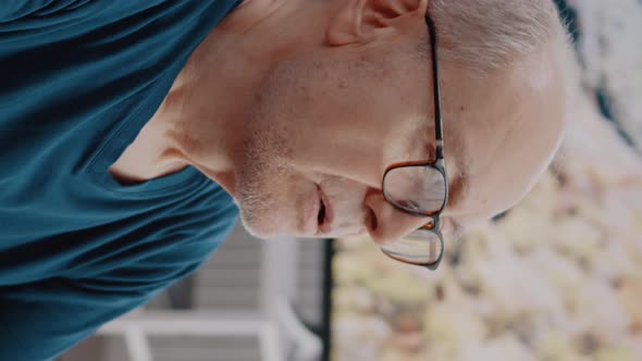 Vertical Video Close Up of Senior Man Doing Wellness Exercise and Breathing