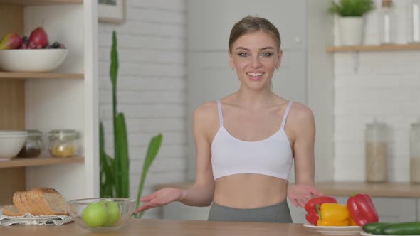 Athletic Woman Doing Video Call While Standing in Kitchen