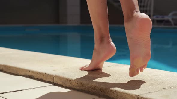 Slim Tanned Legs and Feet of Young Female Model Walk on Floor Near City Public Pool in the Spa