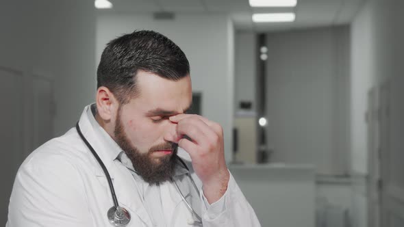 Tired Male Doctor at the Hospital After Long Exhausting Working Day