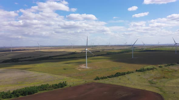 Aerial View Over the Farm Landscape and Wind Turbines Generating Clean Renewable Energy