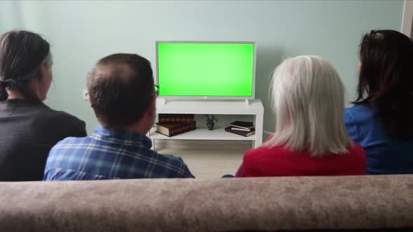 Family Watching TV. Green Screen.