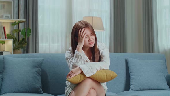 Unhappy Lonely Depressed Young Asian Woman At Home, She Is Sitting On The Couch, Depression Concept