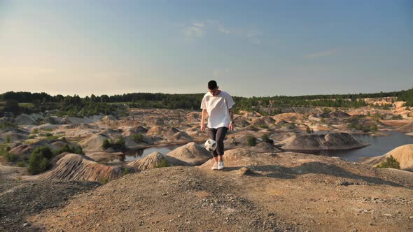 Soccer Freestyler Doing Ball Tricks on Top of a Mountain