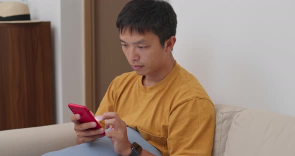Man use of cellphone at home