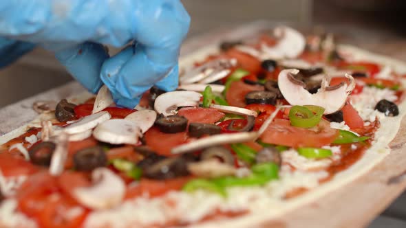 Chef preparing the pizza.