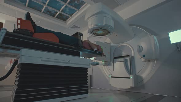 Patient Getting Radiation Therapy Treatment Inside A Modern Radiotherapy Room